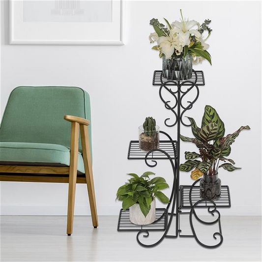 an iron plant stand is showcased with plants and a chair for comparison