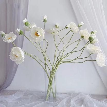 silk poppies on display in a clear vase